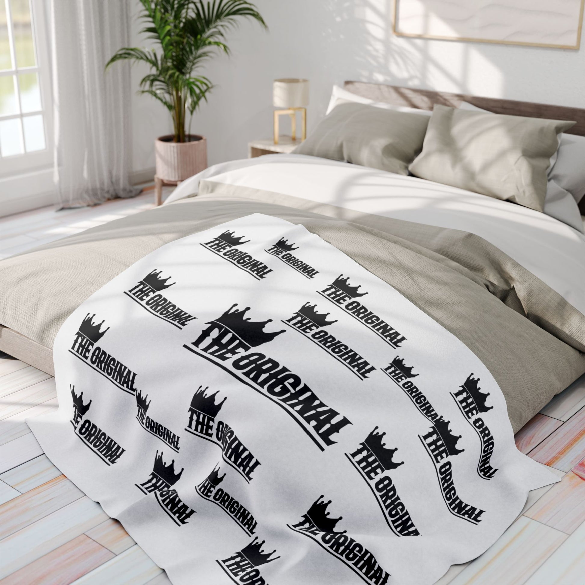 Minimalist white throw blanket with bold black THE ORIGINAL text print
