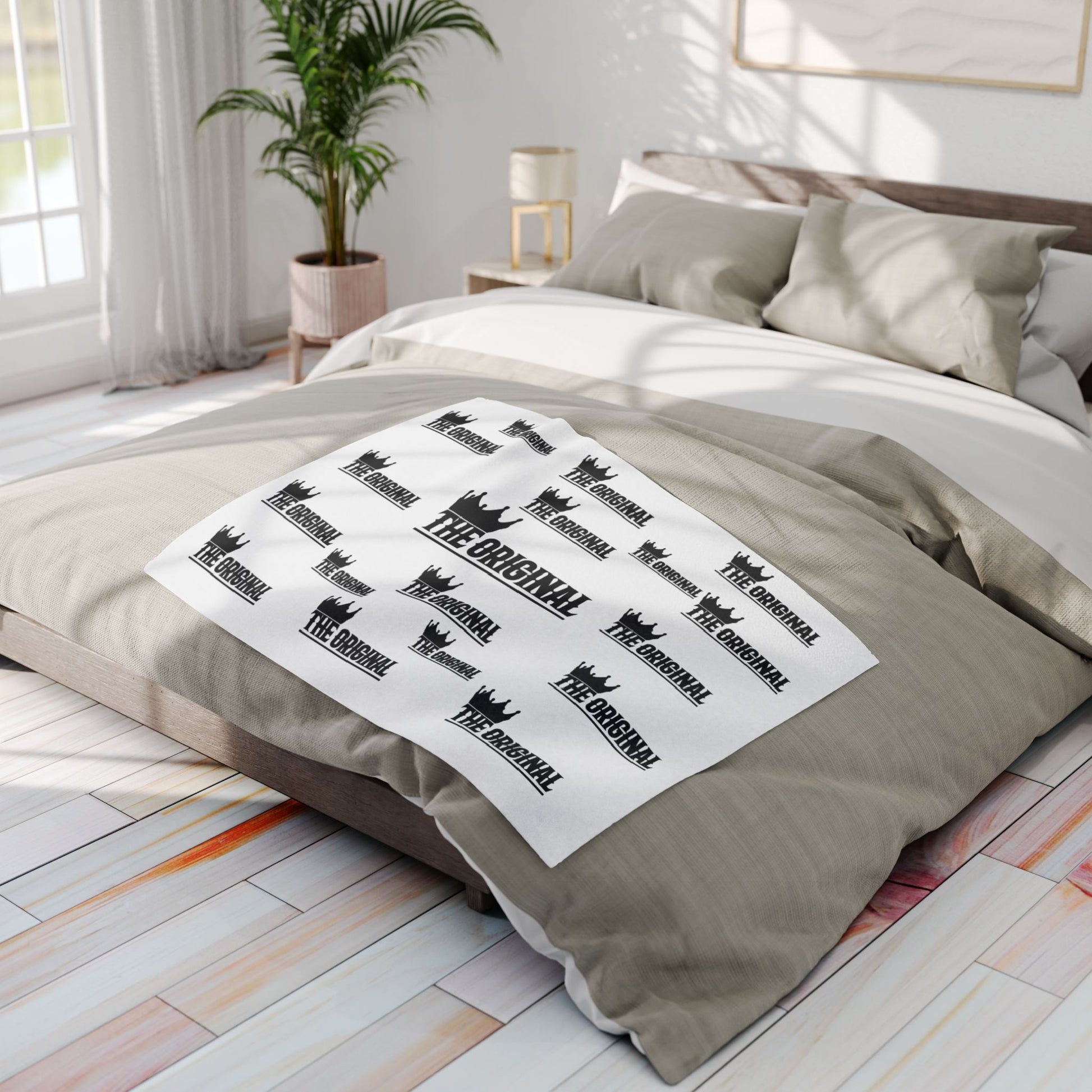 White fleece bed throw featuring black THE ORIGINAL Christian brand name