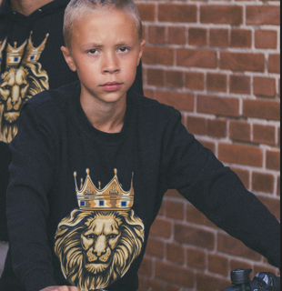 boy in black sweatshirt with GOLD LION imprint